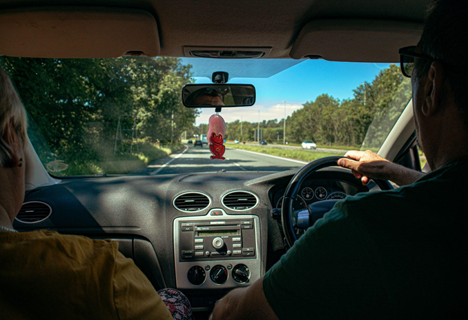 A British couple drives down a highway, representing Veritas Global Protection’s services in Europe